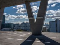 the empty roof is overlooking the city skyline on the sunny day with many clouds in the sky