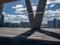 the empty roof is overlooking the city skyline on the sunny day with many clouds in the sky