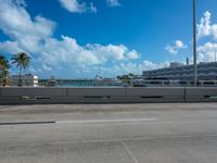 a parking lot with a bunch of buildings in the background and clouds overhead in miami, fl