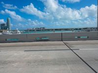 a parking lot with a bunch of buildings in the background and clouds overhead in miami, fl