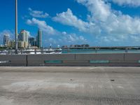 a parking lot with a bunch of buildings in the background and clouds overhead in miami, fl