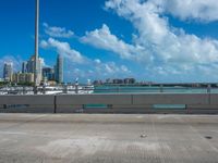 a parking lot with a bunch of buildings in the background and clouds overhead in miami, fl