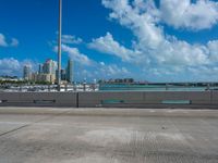 a parking lot with a bunch of buildings in the background and clouds overhead in miami, fl