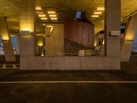 a parking garage filled with lots of cement pillars and windows at dusk with neon lights