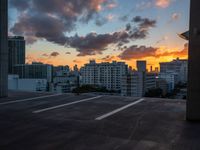 the sun sets over the horizon over a large cityscape with buildings and towers