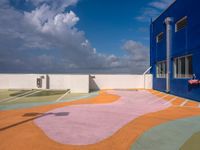the courtyard of an empty building in the daytime light with clouds in the sky above