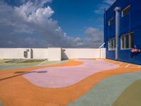 the courtyard of an empty building in the daytime light with clouds in the sky above