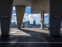 the view from the parking garage of cityscape and buildings on the horizon from the top of an elevated area