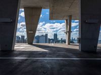 the view from the parking garage of cityscape and buildings on the horizon from the top of an elevated area