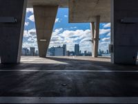 the view from the parking garage of cityscape and buildings on the horizon from the top of an elevated area