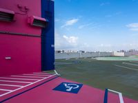 the parking lot on an empty airplane deck looks over the city with its colorful markings