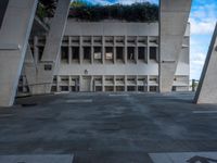 a courtyard outside an office building with stairs leading up to the entrance and steps that lead to it