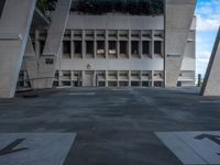 a courtyard outside an office building with stairs leading up to the entrance and steps that lead to it