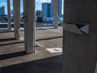 a pole is holding some arrows on it in a parking lot near large buildings, overlooking the city