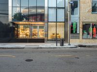 the store is brightly colored in front of the window panes of the building on a busy road