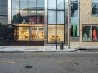 the store is brightly colored in front of the window panes of the building on a busy road