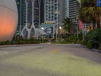 a photo taken from a road at dusk with a large sphere in the middle of it