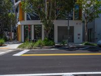 a street with lots of trees in front of it and two traffic lights on either side of the road