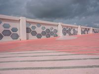 several buildings with colored painted stripes and squares on them are outside the building, with red tile