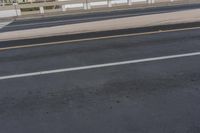a motorcycle is riding down the road on the bridge to go to work as an emergency