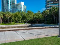 this is a small plaza in front of a tall building on a sunny day,