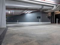 an empty parking garage with no people around it and several storage spaces on the wall