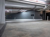 an empty parking garage with no people around it and several storage spaces on the wall