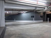 an empty parking garage with no people around it and several storage spaces on the wall