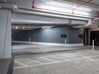 an empty parking garage with no people around it and several storage spaces on the wall