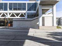 a building that has a road blocked off by a yellow traffic sign on the side walk