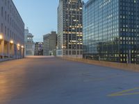 the empty parking lot in front of a building at night time in the city of atlanta