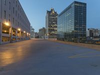 the empty parking lot in front of a building at night time in the city of atlanta