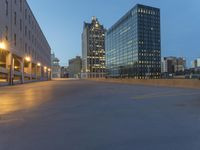 the empty parking lot in front of a building at night time in the city of atlanta