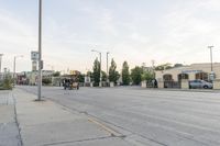 a road with cars, trucks, and people riding on the street with no traffic