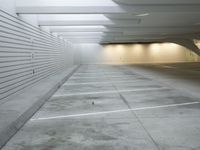 an empty parking garage with some concrete blocks on the walls and ceilings and a black fire hydrant in front