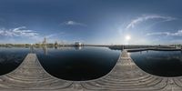 the view from an aerial perspective of a harbor area on a clear day with a reflection of the sun in the water