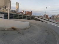 a man riding a skateboard down the side of a ramp on a city street