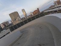 a man riding a skateboard down the side of a ramp on a city street