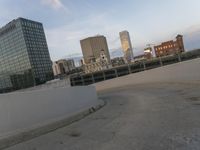 a man riding a skateboard down the side of a ramp on a city street