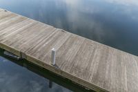 a dock at the water with a white sign on the end of it that says it is empty