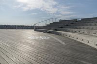 an empty empty auditorium with seating in the sun at a beach town beachfronters