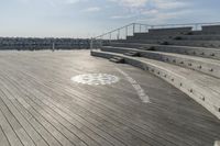 an empty empty auditorium with seating in the sun at a beach town beachfronters