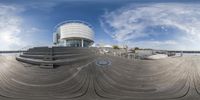 a panoramic view of a building near some steps with stairs going up to it