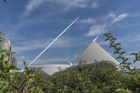 a very tall pyramid in front of some building in the city of arts and sciences