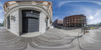 an image of a spherical view of a building and people around it as the camera can see