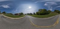 a street view from a 360 - spherical perspective on the road, shows a long winding street