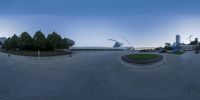 a curved parking lot with an urban landscape in the background as viewed through an umbrella lens