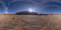 the view looking at a rock on top of the hill, looking very like the sun