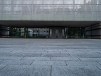 an empty building with several steps and benches in front of it on a grey block