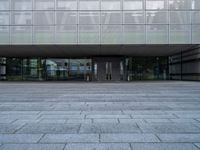 an empty building with several steps and benches in front of it on a grey block